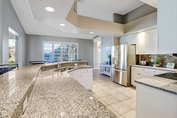 Fridge, microwave, oven, stovetop - 5BR/3BA Waterfront Oasis in Cape Coral | Heated Pool & Spa + Private Dock | Gulf Access (Cape Coral)