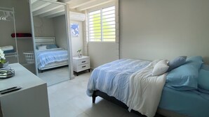 Ein Schlafzimmer mit einem Bett, einem Schreibtisch und einem Kleiderschrank.