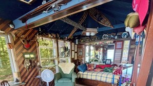 A cozy cabin with a wooden interior, a dining area, and a small kitchen.