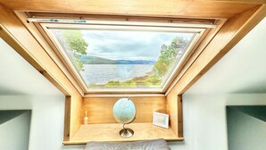 A room with a skylight, a globe, and a framed picture on a wooden shelf. - Spacious Sleeps 10 4 Bedroom Cottage in Inveraray, Fantastic Loch Views and Big Garden (Inveraray)