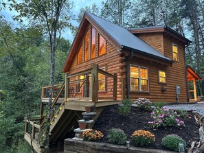 A log cabin with a balcony and a staircase leading up to it. - Sleeps 6, Log Cabin, Covered Hot Tub, Fire Pit, 1.4 Mi to the Parkway (Pigeon Forge)