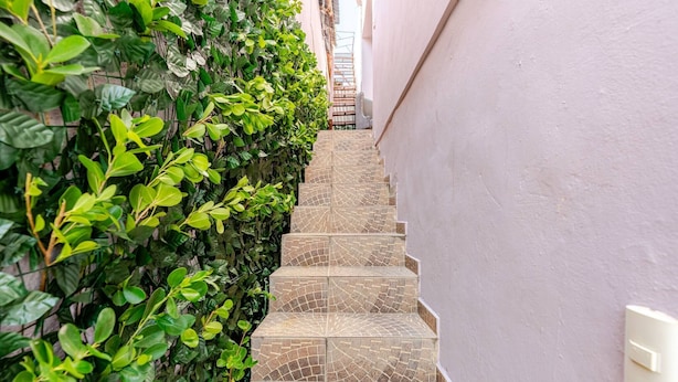 A narrow staircase with patterned tiles leading up to a door. - Una Estancia Moderna y Confortable (Puerto Plata)