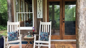 A wooden cottage entrance with two rocking chairs, a small table, and a welcome sign. - Oasis in the Blue Ridge Rt. 151 Brew Ridge Trail-Cozy Cottage in the mountains (Afton)