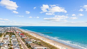 A coastal town with a beach, a pier, and residential buildings along the shore. - NEW! Ocean Condo in Ocean Isle Beach - Beach Access! Breathtaking Views! (Ocean Isle Beach)
