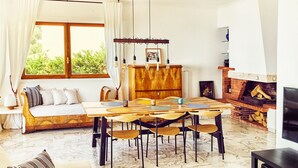 A living room with a wooden dining table, sofa, and fireplace. - Wonderfull view! (Èze)