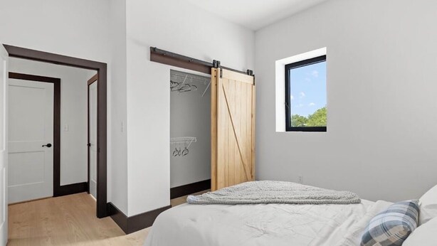 A bedroom with a bed, a window, a wardrobe, and a door. - Welcome to Blue Haven Retreat, beautifull 2- bedroom located in South St. Louis (St. Louis)