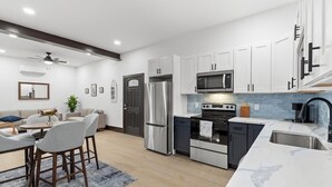 A modern kitchen with white cabinets, stainless steel appliances, and a marble countertop. - Welcome to Blue Haven Retreat, beautifull 2- bedroom located in South St. Louis (St. Louis)