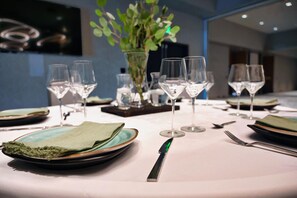 A table set for dining with plates, glasses, and cutlery. - The Mindaro, part of JdV by Hyatt (Portland)