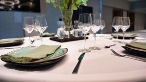 A table set for dining with plates, glasses, and cutlery. - The Mindaro, part of JdV by Hyatt (Portland)