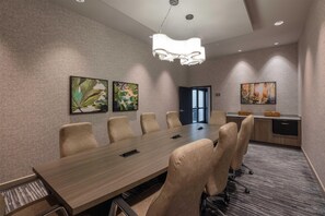 A conference room with a long table, six chairs, and two paintings on the wall. - The Mindaro, part of JdV by Hyatt (Portland)