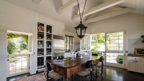 A spacious kitchen with a large island, built-in cabinets, and a view of the garden. - Private Hollywood Hills View Estate 4BR (Los Angeles)
