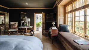 A room with a bed, a sofa, a table with a lamp, and a window with blinds. - Private Hollywood Hills View Estate 4BR (Los Angeles)