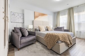 A modern bedroom with a large bed, a sofa, a whiteboard, and a window with curtains. - South Beach Ocean Drive Condo w/ Full Kitchen – Walk to Beach (Miami Beach)