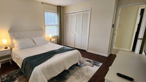 A bedroom with a bed, bedside lamps, a desk, and a wardrobe. - Near Sherman College 2BR w/ Wi-Fi + Washer/Dryer (Boiling Springs)