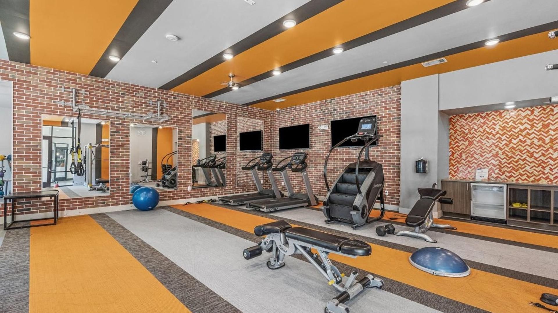 A gym with treadmills, stationary bikes, and weight machines.