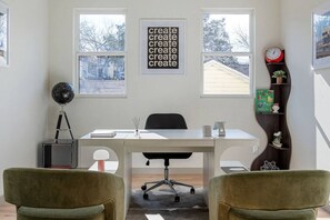 A modern office with a desk, two chairs, a globe on a tripod, a clock, and a bookshelf. - Ultra-Spacious Boutique Retreat in Downtown Dallas (Dallas)