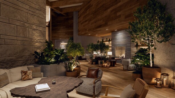 A spacious indoor area with a wooden ceiling, a sofa, a round coffee table, and several potted plants.