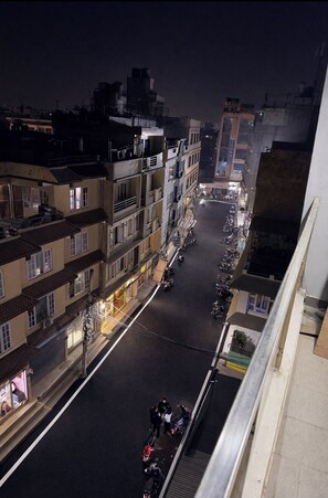 A nighttime street view with buildings, parked motorcycles, and a clear sky. - Charming 3-bedroom apartment . Luxury Penthouse  Stunning Himalayan Views (Kathmandu)