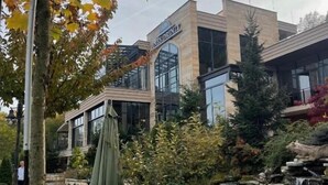 A building with a sign 'JONES DRUMS' and a pond with a waterfall. - Resort Anës Drinit  (Radac)