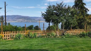 A fenced garden with a view of a lake and mountains. - New 3BR Guest Suite |  Lakeview,  Private Entry (Kelowna)