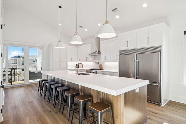 Gather around this stunning modern kitchen where gleaming white countertops invite you to cook and connect with loved ones over breakfast.