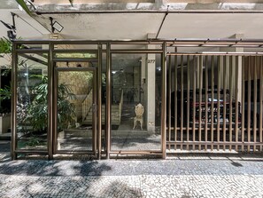 A gated entrance with a glass door, a staircase leading inside, and a tiled pavement. - 10-min Walk to Copacabana Beach | STC302 (Rio de Janeiro)