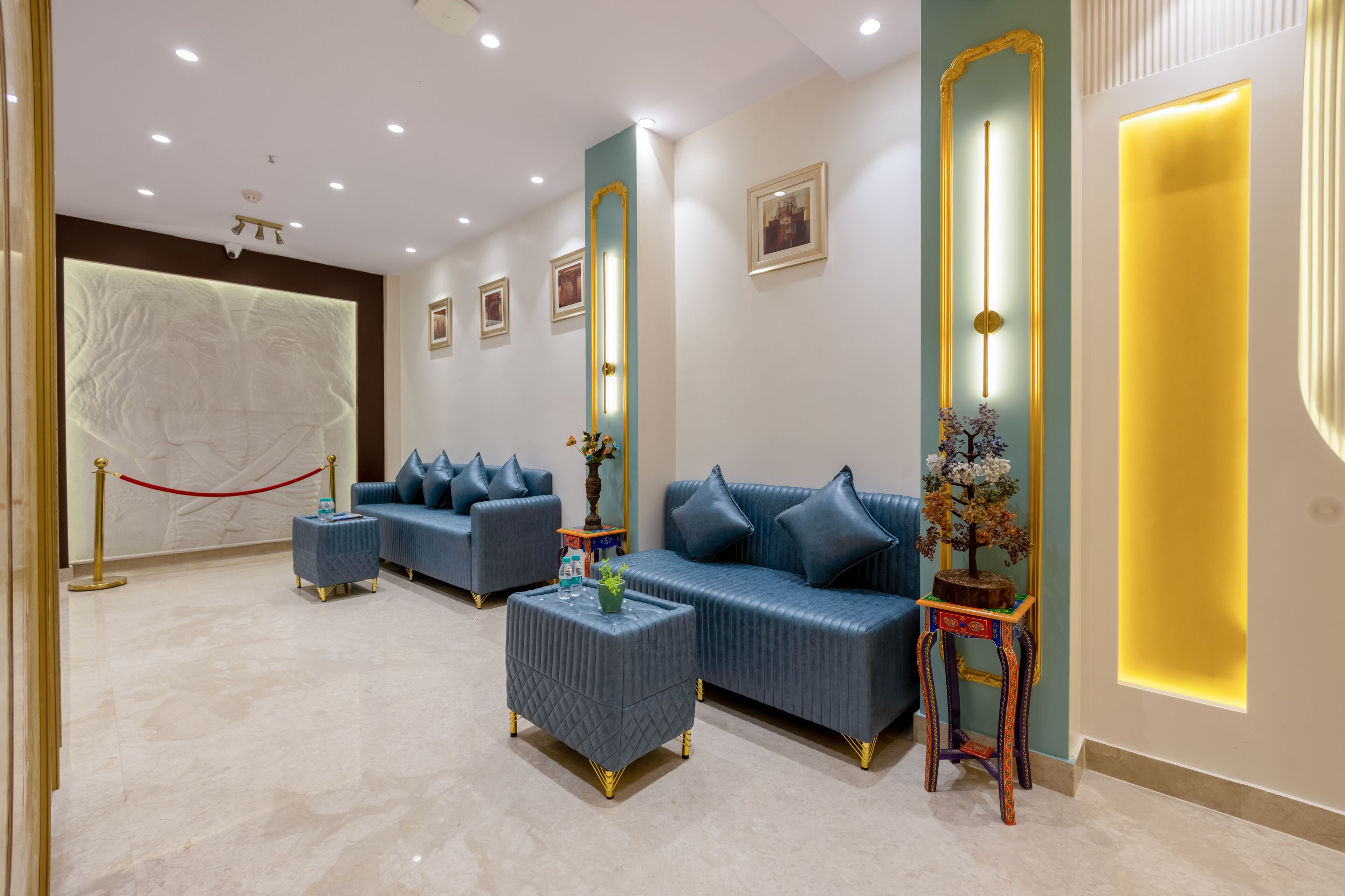 A modern lobby with a reception desk, seating area, and decorative elements.