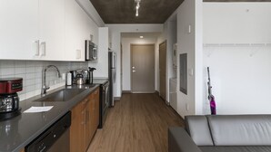 A modern kitchen with stainless steel appliances, a wooden countertop, and a dark ceiling. - Cozy Murphy Hideaway Studio 28 (Birmingham)