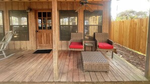A wooden deck with wicker furniture and a ceiling fan. - Escape in Bossier Family & Work-Friendly (Bossier City)