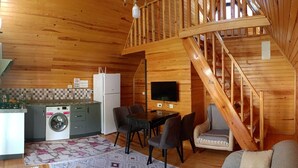 A wooden interior with a kitchen, dining area, and a staircase. - Riviera bungalov apart (Demre)
