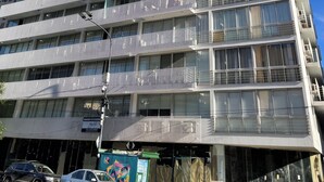 Un edificio a più piani con balconi, ampie finestre e cielo sereno.