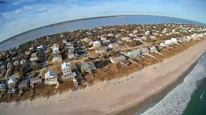 An aerial view of a coastal residential area with houses along the beachfront. - 2 Step - Beachside 3BR/3BA in Emerald Isle, NC (Emerald Isle)