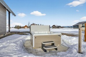 A portable sauna in a snowy outdoor setting with a concrete base and a wooden post. - Timberline Reserve | 2 Homes, Sleeps 28, Hot Tub, Boat Launch, Games! (Island Park)
