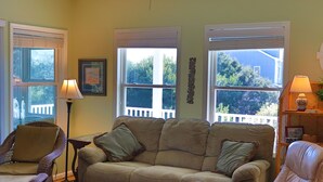 A living room with a sofa, chairs, a table, and a lamp. - 3rd Row Home, Elevator & Ocean View (Emerald Isle)
