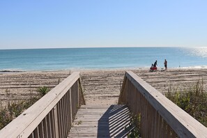 A wooden boardwalk leading to a beach with clear skies. - Ocean Front Reverse Floor Plan with Furnished Decks, Dog Friendly (Emerald Isle)