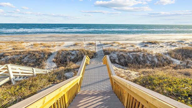 A wooden boardwalk leading to a beach with sand dunes and the ocean in the background. - Family Retreat with Hot Tub & Game Room and Short Walk to Beach (Emerald Isle)
