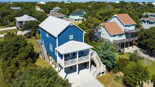 A coastal house with a large deck and a second-story balcony. - Island Retreat, The Ultimate Emerald Isle Getaway! (Emerald Isle)