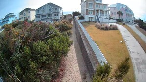 A residential area with houses, a pathway, and a grassy area.