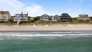 A beachfront property with multiple houses, a sandy beach, and the ocean. - Dog-friendly 5BR Beach Home with Pool & Ocean Views (Emerald Isle)