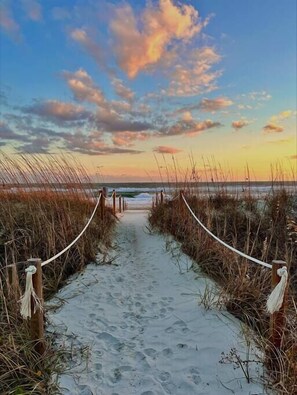 A beach path leading to the ocean with a clear sky above. - Ocean View 4BR Condo – 2 Pools, Tennis & Weekly Rentals (Emerald Isle)