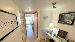 A hallway with a sign reading "Our guest" and another sign welcoming guests to a beachy location.