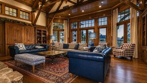 A spacious living room with leather sofas, a coffee table, and a large rug. - AS 110: Luxury Summer Getaway | Cool Temps, Trails & Mountain Views (Snowshoe)
