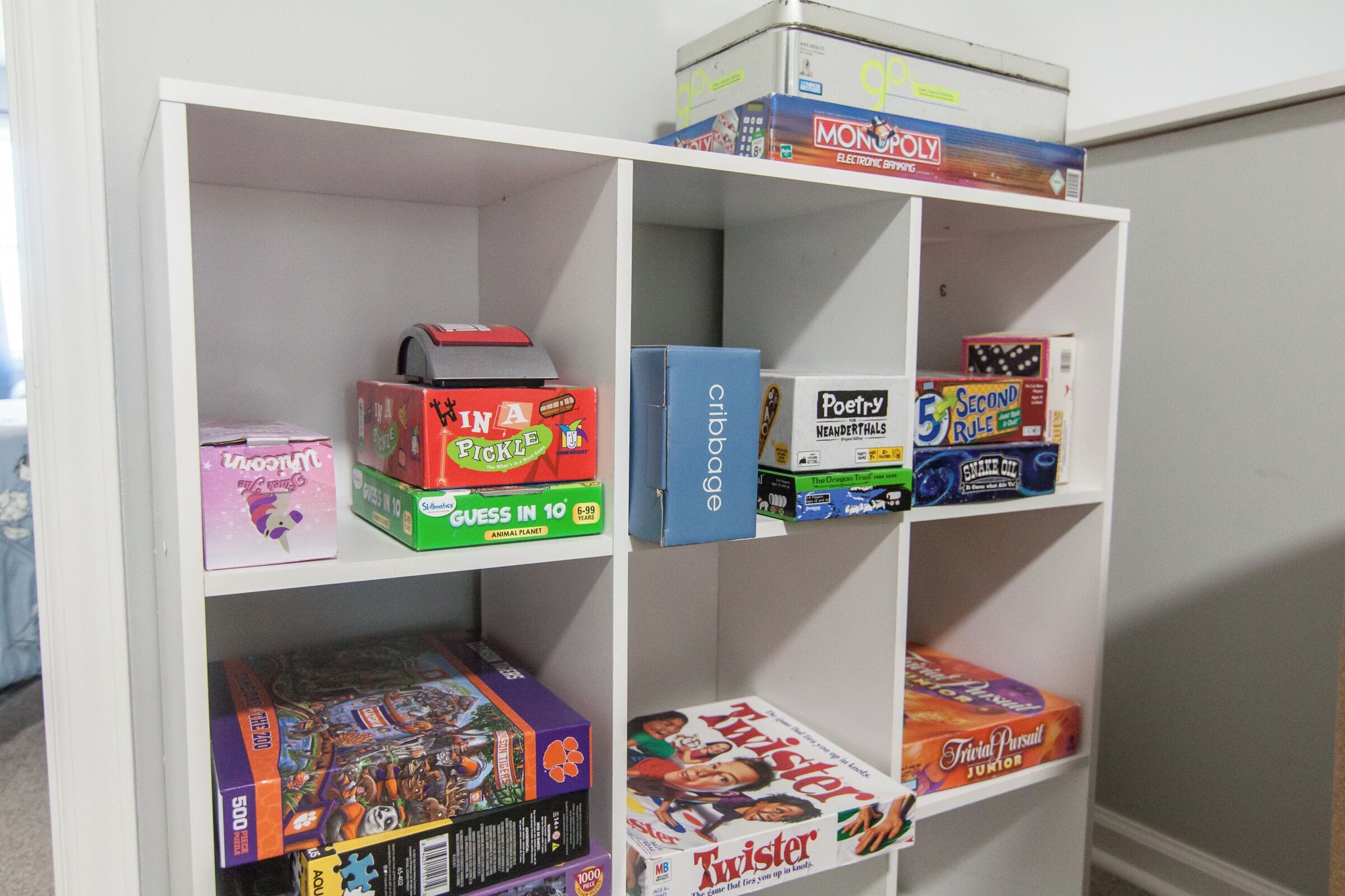 A bookshelf with various board games and puzzles.