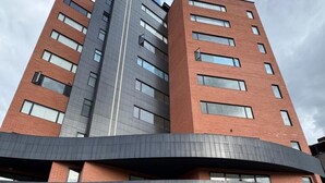 Ein mehrstöckiges Gebäude mit flachem Dach, großen Fenstern und modernem architektonischen Design.