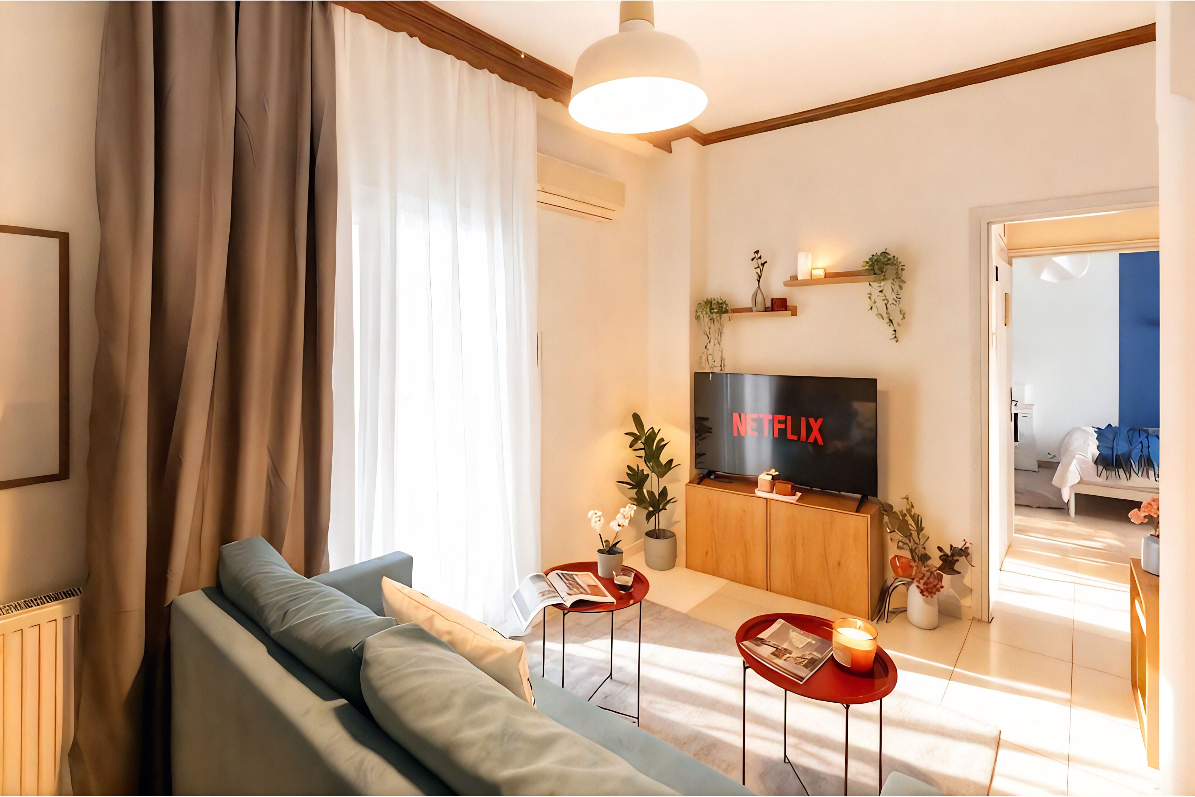 A modern living room with a sofa, a TV, and a coffee table.