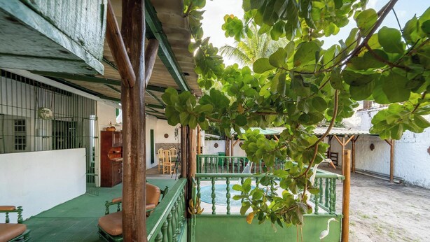 A covered outdoor area with a pool, seating, and a wooden structure. - House w. 5-br and Pool 200m From the Beach Fpl0228 (Cabedelo)