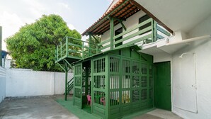 A green playhouse with a staircase, a small pink chair, and a tree in the background. - House w. 5-br and Pool 200m From the Beach Fpl0228 (Cabedelo)