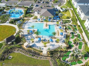 An aerial view of a resort with multiple swimming pools, sun loungers, and palm trees. - Dog-friendly Townhome w/ Private Pool & Resort Water Park - Close to Disney (Davenport)