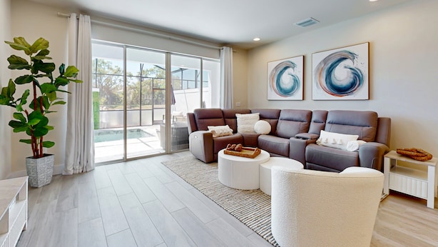A modern living room with a sofa set, a coffee table, a side table, and a potted plant. - Beautiful Home With Private Pool and Space for the Whole Family (Clermont)