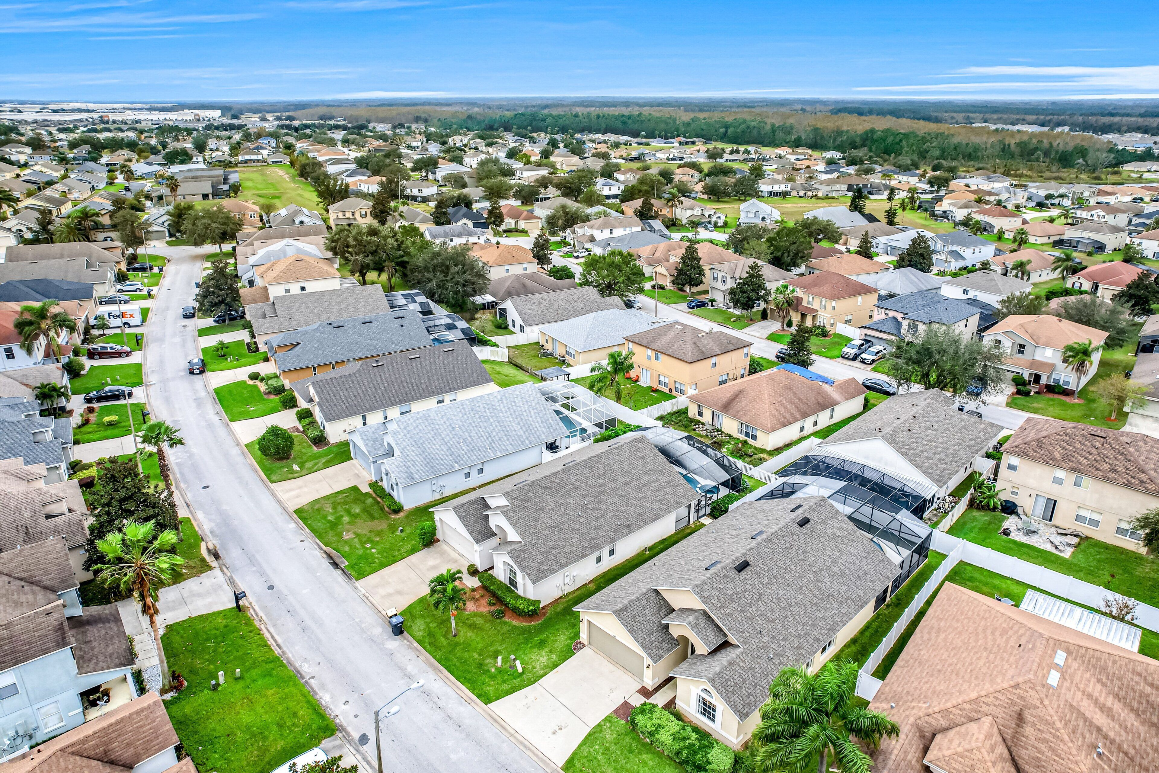 A residential area with houses, streets, and a clear sky.